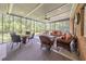 Relaxing screened porch with ample seating, ceiling fan, and view of wooded backyard at 2940 Blue Sky Pl, Marietta, GA 30068