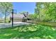 Residential backyard with a grassy lawn, garage, basketball hoop, and wooden fence at 5023 Buckline Xing, Dunwoody, GA 30338