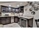 Basement bar featuring custom cabinetry, granite countertops, and dual beverage coolers at 5023 Buckline Xing, Dunwoody, GA 30338