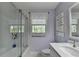Modern bathroom featuring tub with glass doors, tile surround, and contemporary fixtures at 5023 Buckline Xing, Dunwoody, GA 30338
