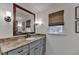 Bathroom vanity features granite countertops, undermount sink, and framed mirror at 5023 Buckline Xing, Dunwoody, GA 30338