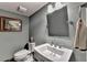 Modern powder bathroom featuring a sleek vanity, decorative mirror, and framed art at 5023 Buckline Xing, Dunwoody, GA 30338