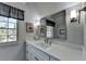 Bright bathroom featuring a window, large mirror, sleek faucet, and a 'No Lifeguard On Duty' sign at 5023 Buckline Xing, Dunwoody, GA 30338