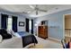 Bright bedroom featuring blue walls, ceiling fan, and a cozy bed with dresser at 5023 Buckline Xing, Dunwoody, GA 30338