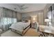 Cozy bedroom features neutral walls, ceiling fan, and a comfortable bed with bench seating at 5023 Buckline Xing, Dunwoody, GA 30338