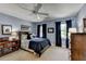 Inviting bedroom with blue walls, ceiling fan, and ample natural light at 5023 Buckline Xing, Dunwoody, GA 30338