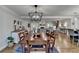 Open concept dining area featuring modern lighting and hardwood floors seamlessly connecting to other rooms at 5023 Buckline Xing, Dunwoody, GA 30338