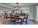 Open concept dining area featuring modern lighting, hardwood floors, and a seamless flow to other rooms at 5023 Buckline Xing, Dunwoody, GA 30338
