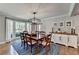Inviting dining area with hardwood floors, bright lighting, and windows overlooking the outdoor landscape at 5023 Buckline Xing, Dunwoody, GA 30338