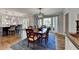 Dining area with hardwood floors, pendant lighting, and an open layout leading to the kitchen and living spaces at 5023 Buckline Xing, Dunwoody, GA 30338