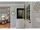 Stylish entryway with a unique Dutch door, modern decor, and a glimpse into the living room at 5023 Buckline Xing, Dunwoody, GA 30338