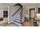 Spacious foyer with hardwood floors, staircase with wood and iron banister, and views into other rooms at 5023 Buckline Xing, Dunwoody, GA 30338