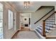 Inviting foyer showcases hardwood floors, a staircase with a dark wood banister, and decorative glass front door at 5023 Buckline Xing, Dunwoody, GA 30338