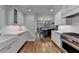 Bright kitchen features white cabinetry, stainless steel appliances, and subway tile backsplash at 5023 Buckline Xing, Dunwoody, GA 30338