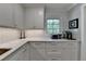 Bright kitchen area with white cabinets, marble counters, and modern appliances at 5023 Buckline Xing, Dunwoody, GA 30338