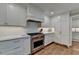 Contemporary kitchen with stainless steel appliances, white cabinets, and marble countertops at 5023 Buckline Xing, Dunwoody, GA 30338