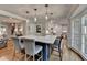 Stylish kitchen island with seating, pendant lights, and view to the living area at 5023 Buckline Xing, Dunwoody, GA 30338