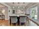 Kitchen island with marble countertop, seating, and view of the modern kitchen at 5023 Buckline Xing, Dunwoody, GA 30338