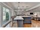 Bright kitchen island with marble countertop, seating, and large windows at 5023 Buckline Xing, Dunwoody, GA 30338