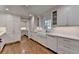 Modern kitchen with white cabinetry, marble countertops, and stainless steel appliances at 5023 Buckline Xing, Dunwoody, GA 30338