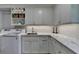 Bright laundry area featuring marble countertops, white cabinets, and modern appliances at 5023 Buckline Xing, Dunwoody, GA 30338