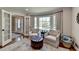 Cozy home office features ample light, comfortable seating, and built-in shelving with french doors at 5023 Buckline Xing, Dunwoody, GA 30338
