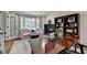 Bright and well-equipped home office with bay window, built-in shelving and a large work desk at 5023 Buckline Xing, Dunwoody, GA 30338