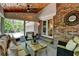 Welcoming screened-in porch with ample seating, brick accents, and wood-paneled ceiling at 5023 Buckline Xing, Dunwoody, GA 30338