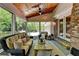 Cozy screened-in porch featuring comfortable seating, rustic coffee table, and wood-paneled ceiling at 5023 Buckline Xing, Dunwoody, GA 30338