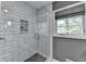 Modern shower featuring white subway tiles, a glass door, and a built-in niche at 5023 Buckline Xing, Dunwoody, GA 30338