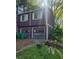 View of the two-car garage of a purple home with off-white trim and shutters at 6150 Silver Spur Dr, Lithonia, GA 30058