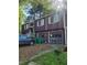 View of a two-story home with attached two-car garage, accented by off-white shutters and trim at 6150 Silver Spur Dr, Lithonia, GA 30058