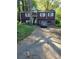 Two-story home with a two-car garage and a long driveway in a wooded surrounding at 6150 Silver Spur Dr, Lithonia, GA 30058