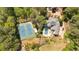 Expansive property featuring a home, pool, tennis court, and lush landscaping as seen from above at 4366 Karls Gate Dr, Marietta, GA 30068