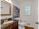 Elegant powder room features dark wood vanity, granite countertop, and decorative mirror at 4366 Karls Gate Dr, Marietta, GA 30068