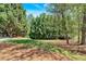 Manicured lawn with mature trees and landscaping offering privacy and curb appeal at 4366 Karls Gate Dr, Marietta, GA 30068