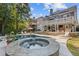 Backyard oasis featuring an in-ground pool, waterfall, hot tub, lounge area and patio at 5724 Kendrick Ln, Cumming, GA 30041