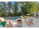Backyard featuring an in-ground pool and surrounding patio space with outdoor seating and a fire pit at 5724 Kendrick Ln, Cumming, GA 30041
