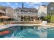 Resort-style backyard with a refreshing pool, spacious deck, and lush landscaping perfect for outdoor entertaining at 5724 Kendrick Ln, Cumming, GA 30041