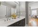This bathroom features double sinks, vanity, and a decorative mirror, perfect for a quick refresh at 5724 Kendrick Ln, Cumming, GA 30041