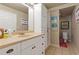 This bathroom has a vanity with lots of storage and a toilet area, enhanced by unique wall art at 5724 Kendrick Ln, Cumming, GA 30041