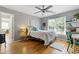 This bedroom features hardwood floors, ceiling fan, natural light, closet, and study area at 5724 Kendrick Ln, Cumming, GA 30041