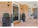 Inviting front porch with brick accents, stylish décor, and a welcoming entrance at 5724 Kendrick Ln, Cumming, GA 30041