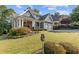 Beautiful home with lush landscaping and a charming front porch, showcasing curb appeal at 5724 Kendrick Ln, Cumming, GA 30041