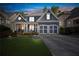 Charming two-story home with a well-manicured lawn and inviting front porch at 5724 Kendrick Ln, Cumming, GA 30041