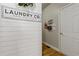 Convenient laundry area featuring shiplap accent wall and ample storage space, making chores a breeze at 5724 Kendrick Ln, Cumming, GA 30041