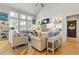 Inviting living room with vaulted ceilings, large windows, and a cozy fireplace creates a perfect gathering space at 5724 Kendrick Ln, Cumming, GA 30041
