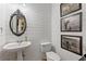Stylish powder room with shiplap walls, elegant mirror, and charming cow-themed artwork provides a sophisticated touch at 5724 Kendrick Ln, Cumming, GA 30041