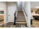 View of the staircase featuring modern design, carpeted steps, black rails, and a nearby recreational area at 5724 Kendrick Ln, Cumming, GA 30041