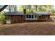 Backyard view of home with an attached deck, set on a large lot at 285 Glen Ne Rd, Conyers, GA 30013